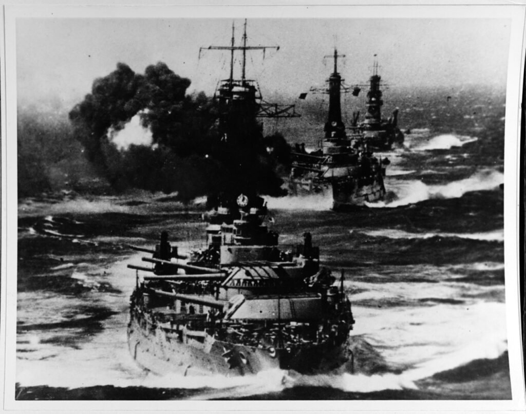 Two New York Class Battleships firing during exercises.